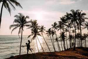 couple love meets sunset sea among palm trees boy girl sunset honeymoon islands man woman meet sunset happy loving couple silhouette lovers wedding travel 1