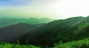 beautiful dramatic sunset sky clouds rocky mountain top view covered by green forest nature background adventure trekking hill